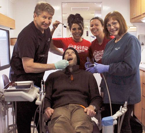 Dental team volunteers give this Fish for Teeth patient the royal treatment. From left