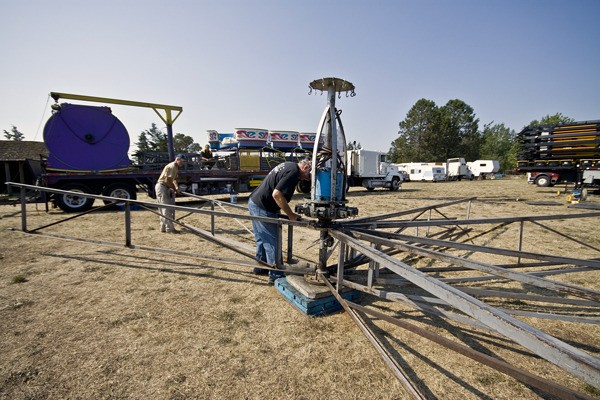 Paradise Amusements employees set up carnival rides Monday in preparation for the four-day San Juan County Fair