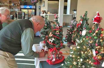 San Juan Island's Tom Cable registers for a chance to purchase a hand-decorated Christmas tree at Peace Island Volunteers' holiday luncheon