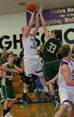 Collin Williamson (32) sinks two of his 13 points over the outstretched arm of Bear Creek’s Connor Thomas.