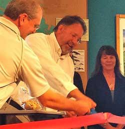 From left; Mike Martin and Duncan Wilson wield the ceremonial scissors at Whale Tale Cookies company launch and ribbon-cutting celebration