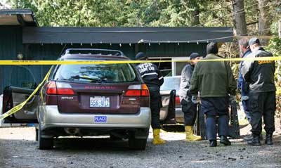 Federal ATF agents and state Crime Lab investigators join in the examination of the scene of Sunday's deadly fire in Friday Harbor.