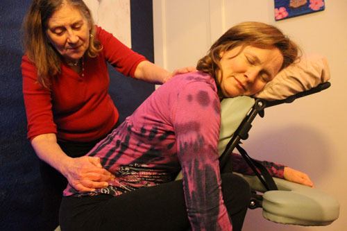 Massage therapist Linda Drake works out some kinks for Tamara Kay Dean.
