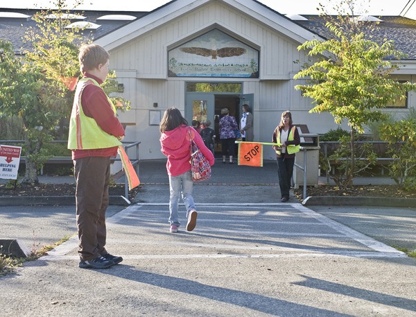 Children cross from the parking lot to the entrance to Friday Harbor Elementary School on the first day of school