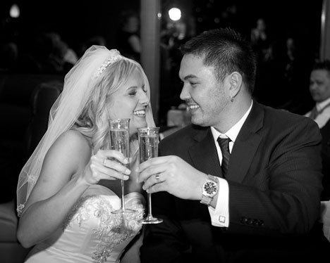 Newlyweds Carrie Burke and Juan Unpingco celebrate their marriage with a champagne toast at Downriggers Restuartant on Valentine's Day.