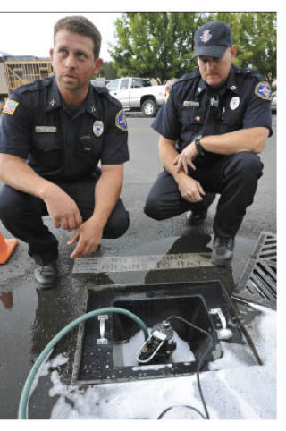 Capt. Tony Smith and firefighter Nathan Mauldin demonstrate the new SudSafe system.