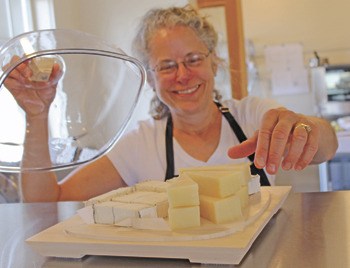 Sherri Daly of San Juan Island Cheese displays a selection of the the Nichols Street eatery’s featured items.