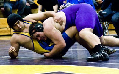 Heavyweight Willy Dunn scores a take-down in an exhibition match against Tacoma Baptist’s William Edge