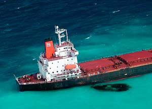 Four tons of oil spilled from a Chinese coal carrier after it struck a reef the coast of Australia