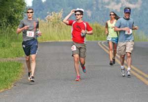 Runners round a bend on Wold Road in the 2013 San Juan Island marathon