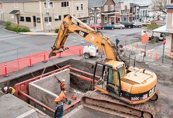 Construction workers install a ‘water vault’ at the intersection of First and Spring streets in mid-April.