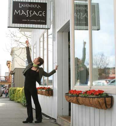 Ciely Ti Gray of Lavendera Massage points out the sign at the businesses new location