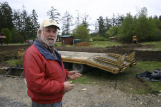Terry Lush talks about landscaping plans for the area outside of his San Juan Business Park. A cottage