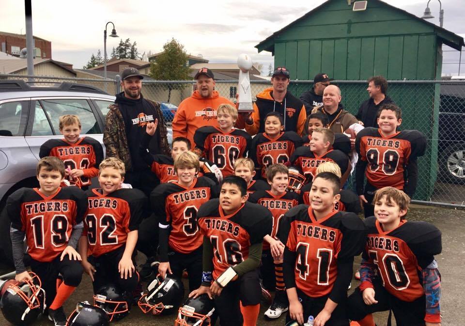 Little league football teams win championship trophies The Journal of