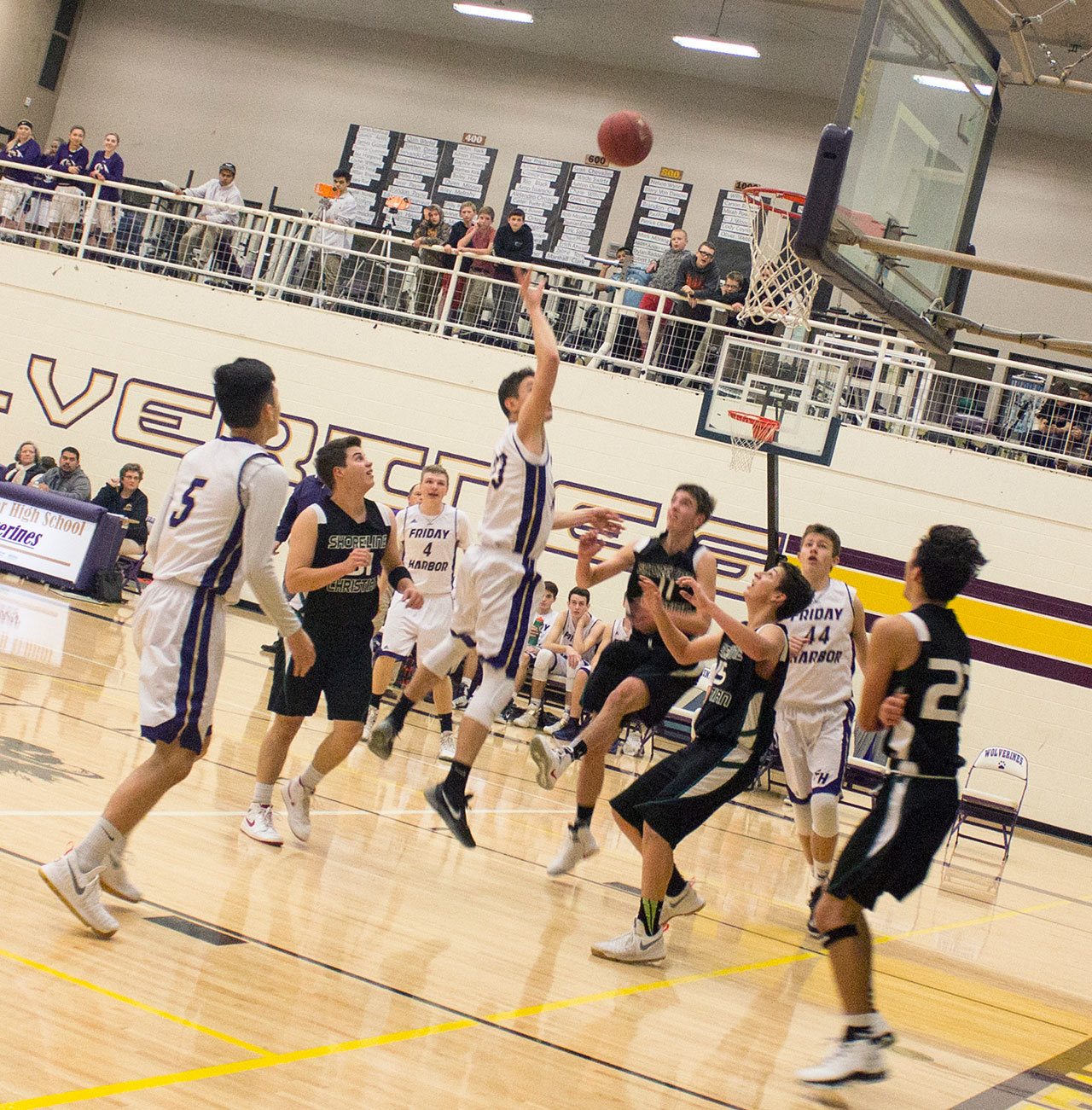 Staff photo/Greg Sellentin                                Senior John Gustafson grabs a rebound and scores.