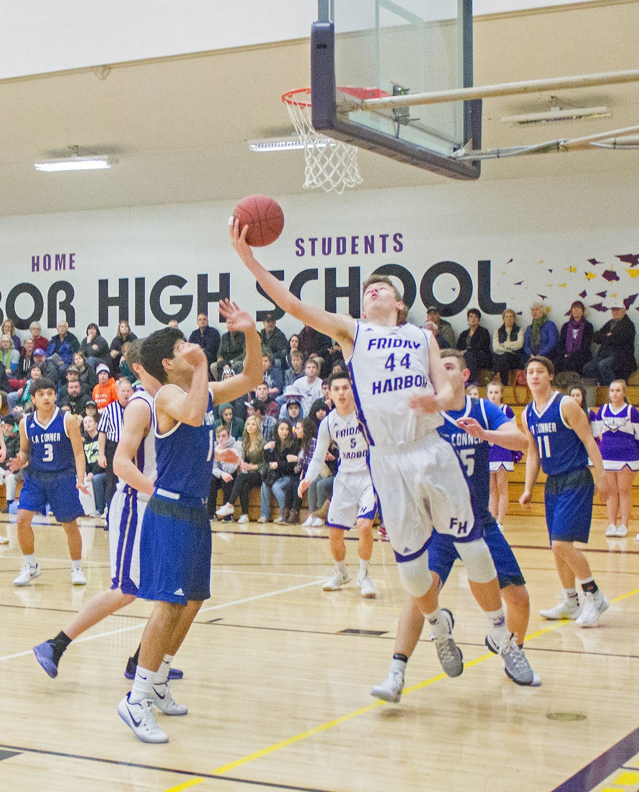 Staff photo/Greg Sellentin                                Sophomore Marshall Clark wrestles a rebound and scores from under the hoop.