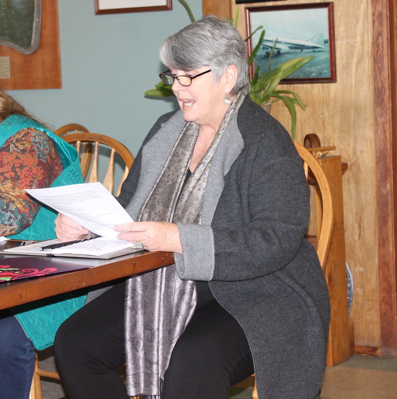 Staff photo/Hayley Day                                Gretchen Krampf reads quality and character recommendations for a new director from port staff at the Jan. 25 meeting. Krampf was hired by the port to compile the recommendations.