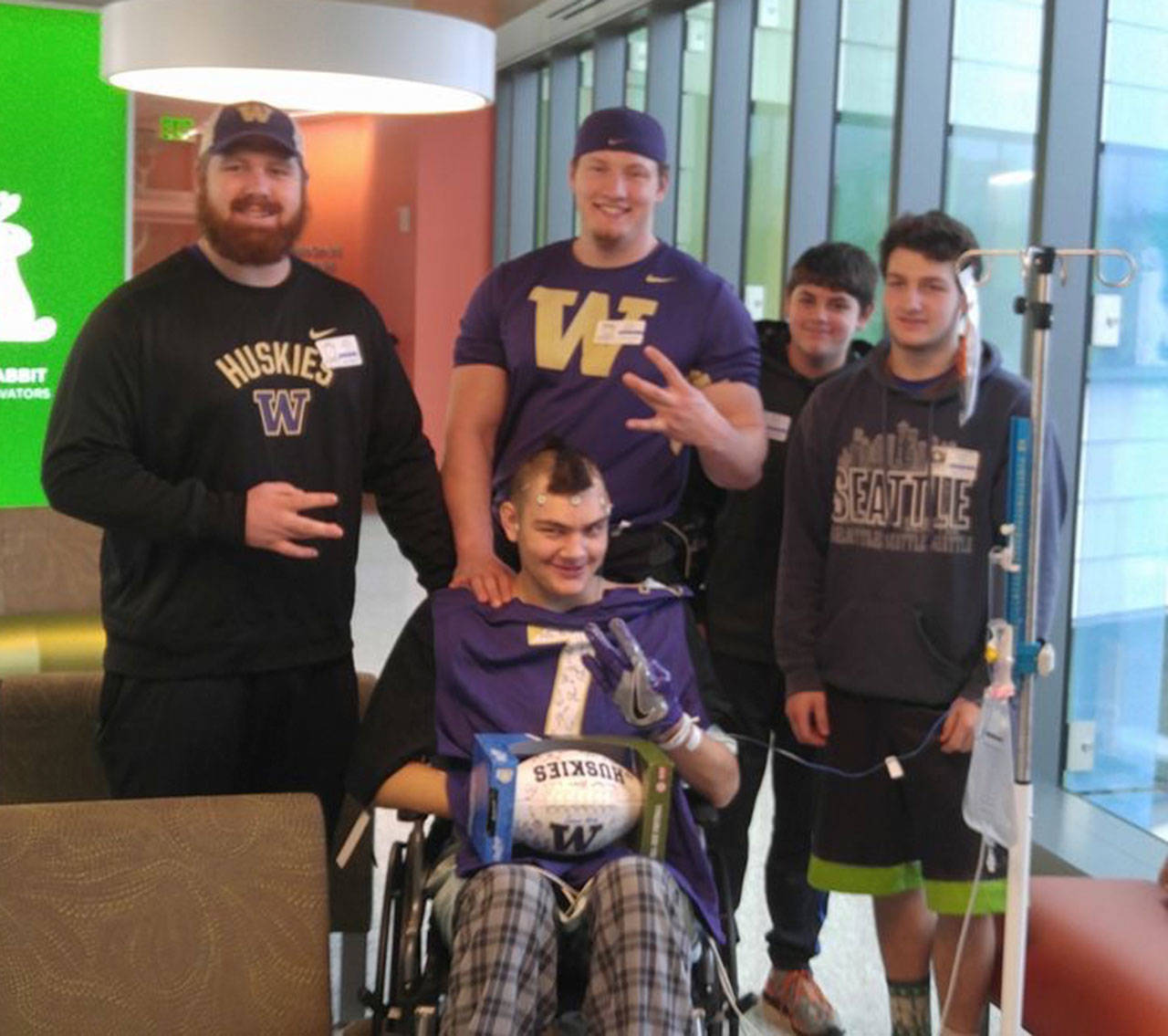 Contributed photo                                University of Washington football players visit Friday Harbor High School sophomore Quincy Vague in the hospital. Vague was diagnosed with an inoperable brain tumor last February.