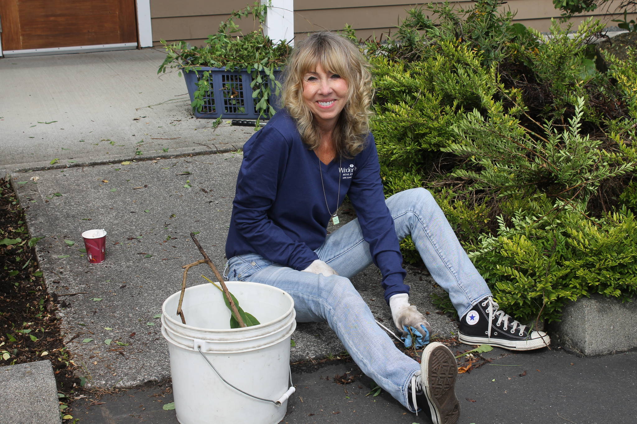 Staff photo. Daryl Grazia pulling weeds at the Senior Center.