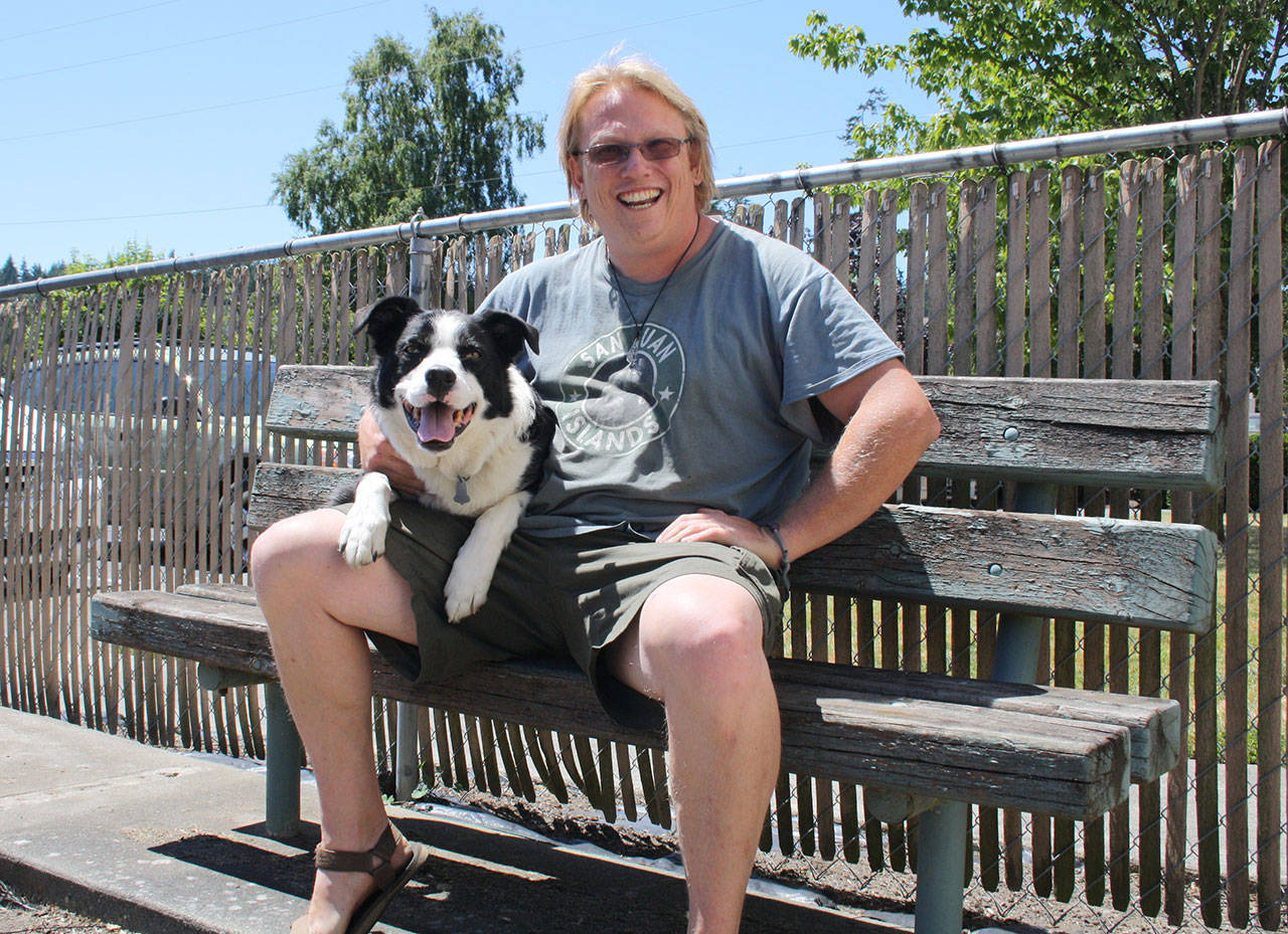 Tyler Harrison and his border collie Tango have lived in Harbor View apartments for about six years. If the building sells to a for-profit company, its income-based rent could stop.