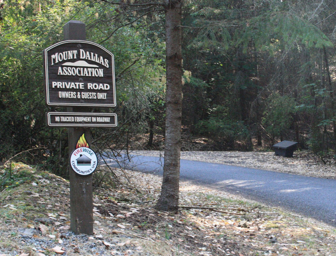 Staff photo/Hayley Day                                The sign to enter the development on Mount Dallas includes the name of the association that could manage some aspects of road maintenance payments.