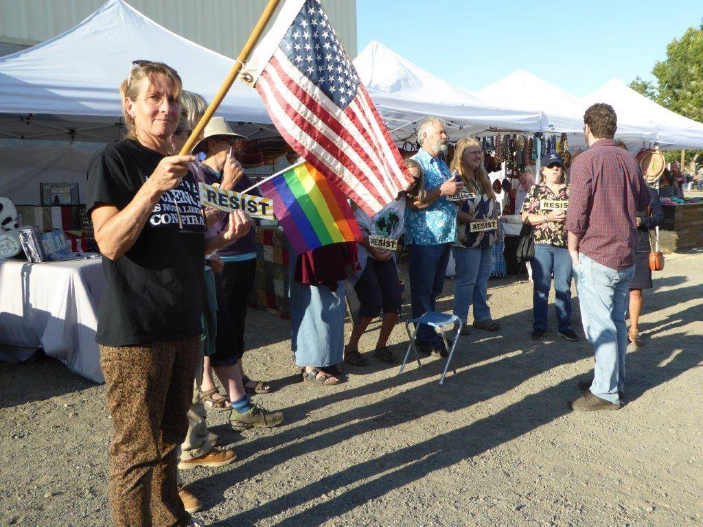 Protesters at the Republican booth at the San Juan County Fair