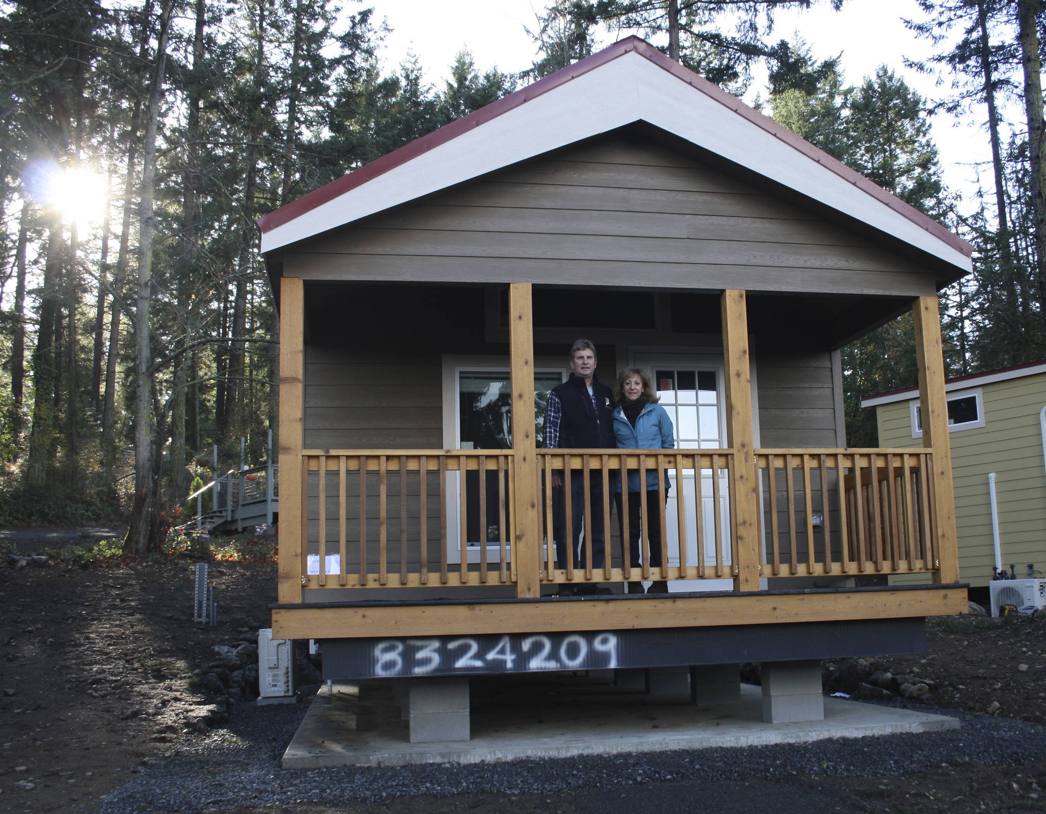 Staff photo/Hayley Day                                Anna Maria de Freitas and David Pass stand on the covered deck of a tiny house they will rent out in Friday Harbor. Each house comes with a 90-square-foot covered deck in the front.
