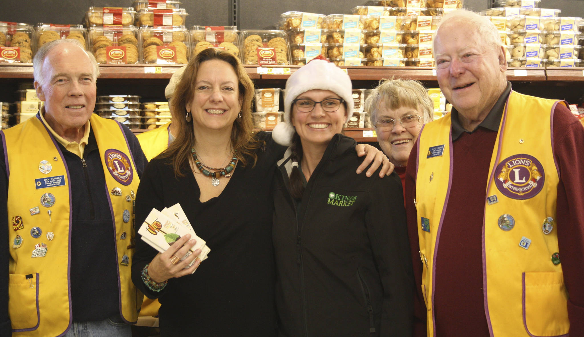 Staff photo/Hayley Day                                Shahn McGuire and San Juan Lions Club members gather in front of the collected items after the spree.