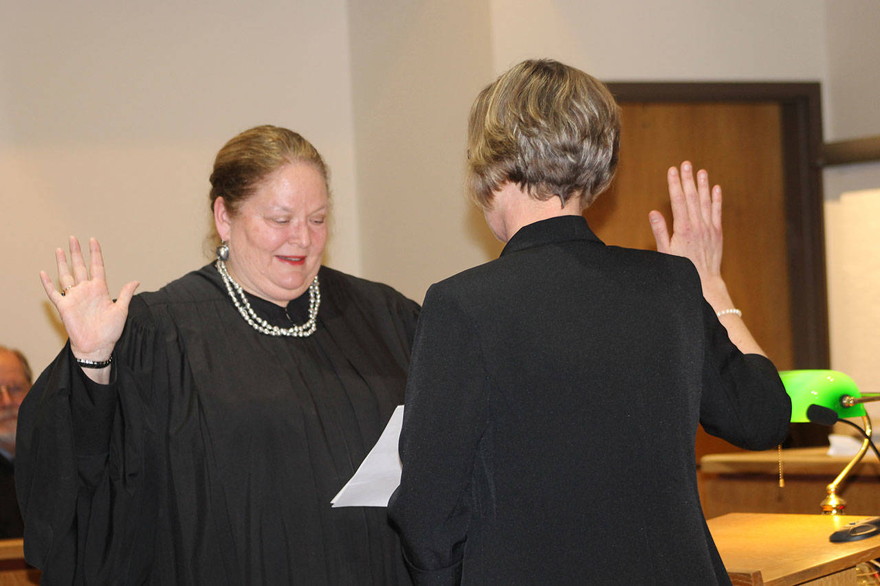 Staff photo/Heather Spaulding Judge Washington State Supreme Court Judge Mary Fairhurst swears Katie Loring in as San Juan County Superior Court judge.