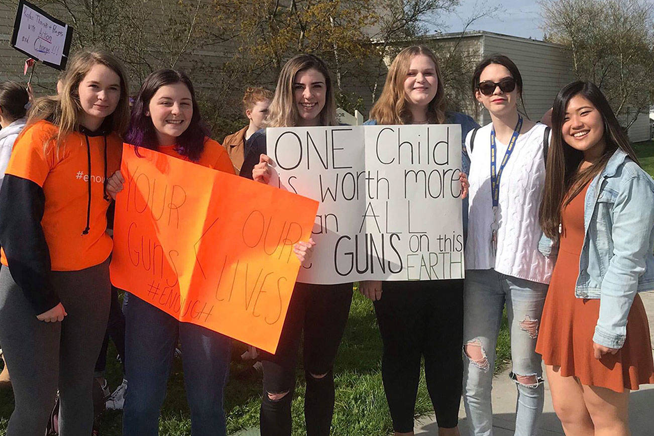 Contributed photo                                Students hold signs during the April 20 walkout.