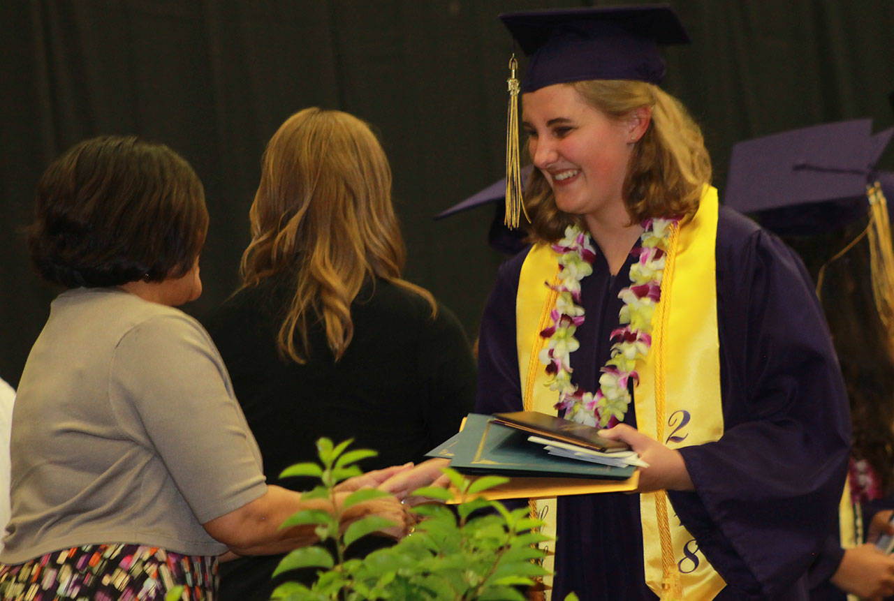 Staff photo/Heather Spaulding. Tenly Nelson receives her diploma.