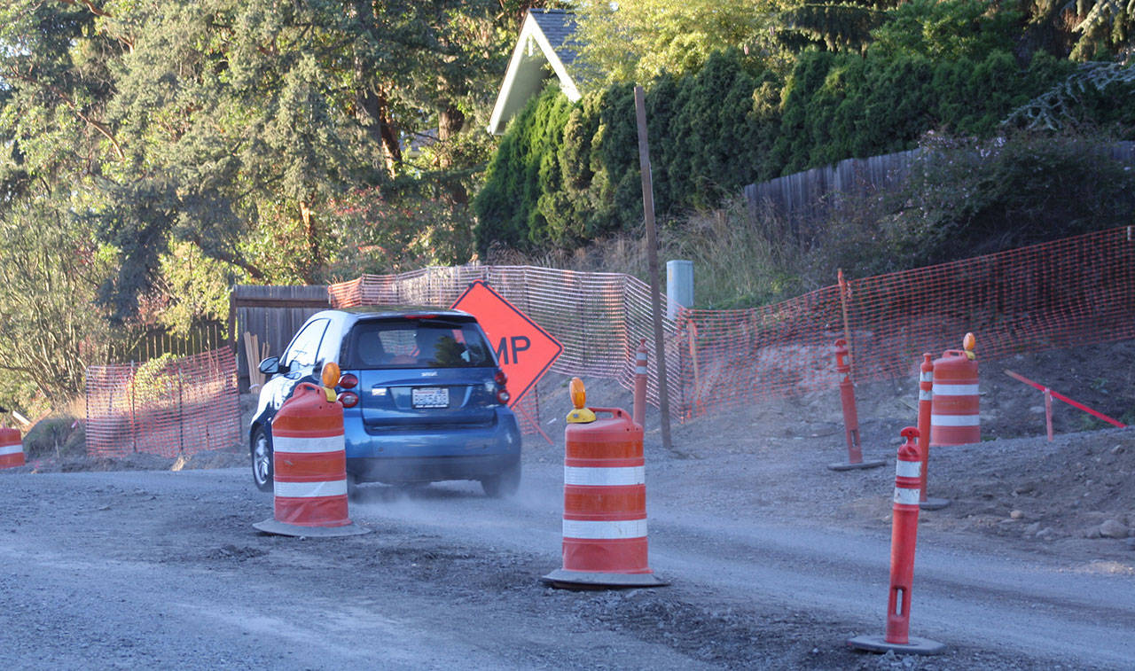 Staff photo/Hayley Day                                A car drives past Perry Place through the Tucker Avenue construction.