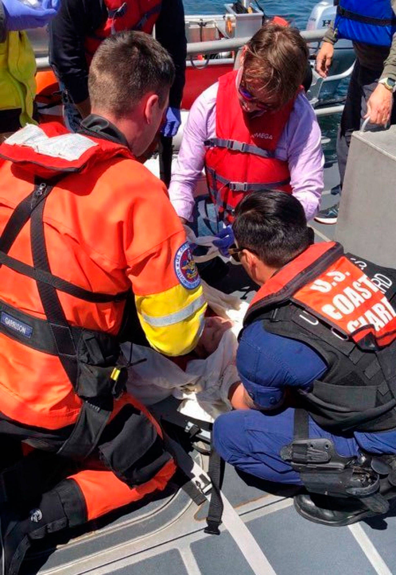 Contributed photo/Petty Officer 1st Class Levi Read, U.S. Coast Guard District 13                                An aviation survival technician and Petty Officer 3rd Class Jordan Harlacher assist with medical care given to a 70-year-old woman injured during a sailing accident near Sucia Island.