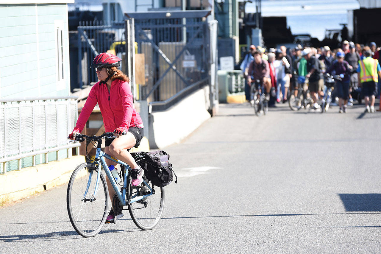 Staff photo/Tate Thomson                                Cyclists disembark on the ferry to San Juan Island.
