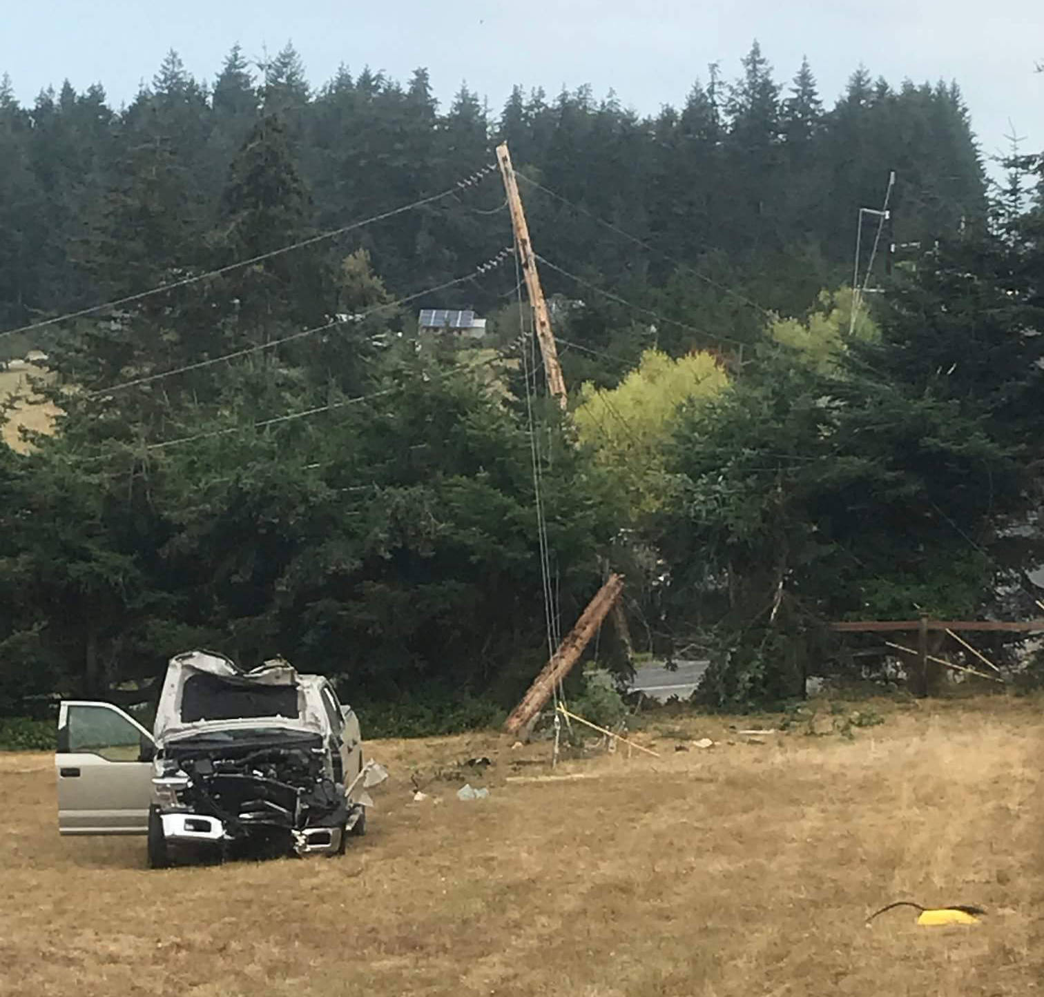 Contributed photo/OPALCO                                A medical emergency caused a truck to hit a transmission pole on Lopez Island, which also caused a grass fire. The driver was flown off the island for observation and to treat relatively minor injuries.