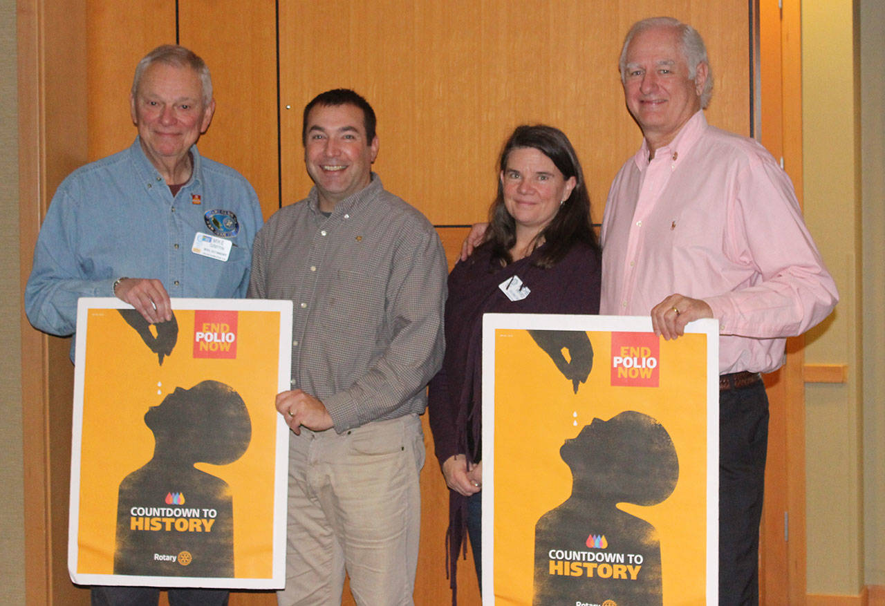 Staff photo/Hayley Day                                Local Rotary Club members Mike Griffin, Adam Eltinge, Michel Vekved and Paul Mayer stand with the clubs’ posters promoting efforts to eliminate polio.