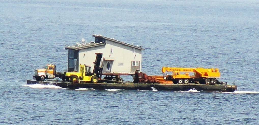 Contributed photo/OPAL                                An OPAL house is barged to Orcas Island.