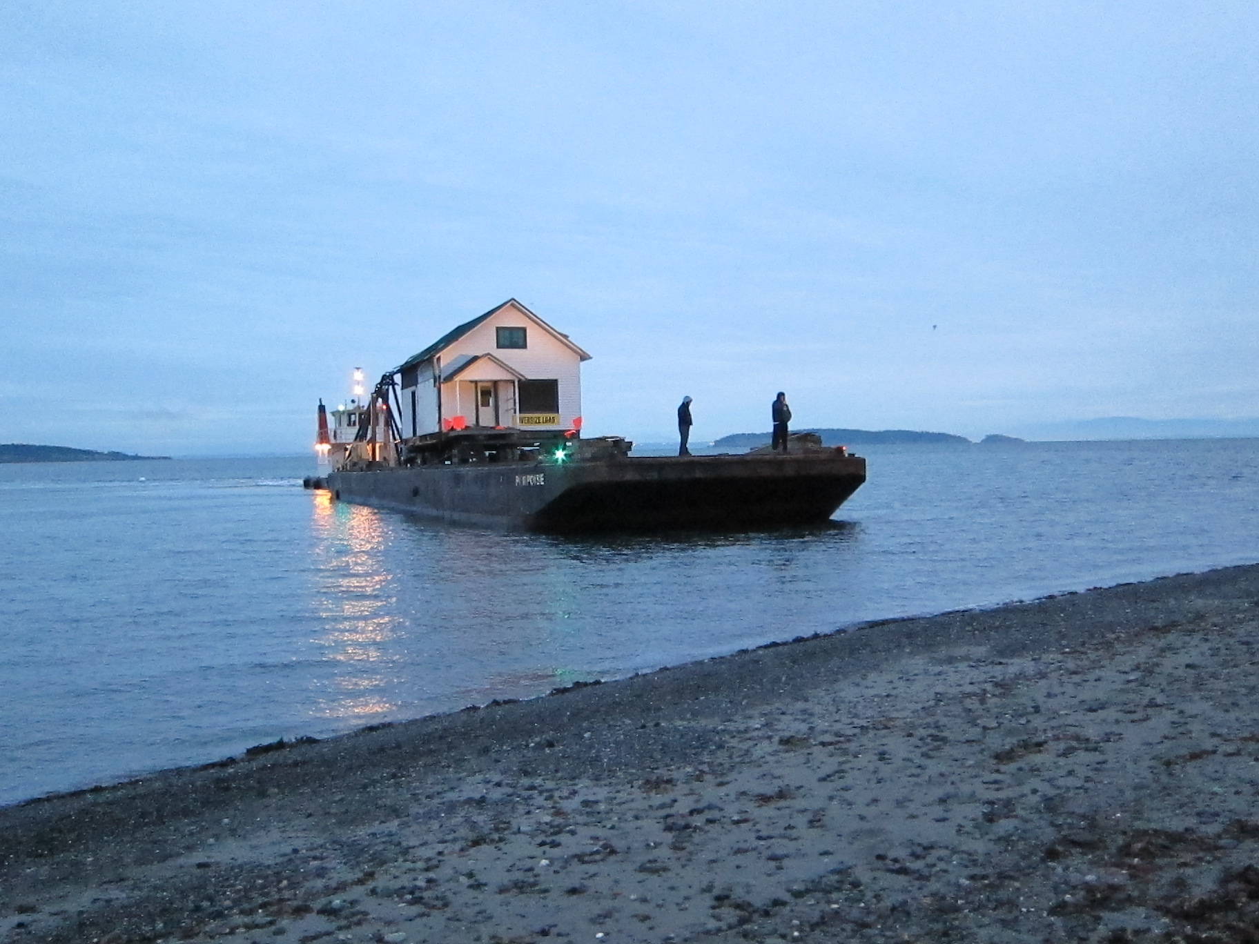 Contributed photo/OPAL                                An OPAL house is barged to Orcas Island.