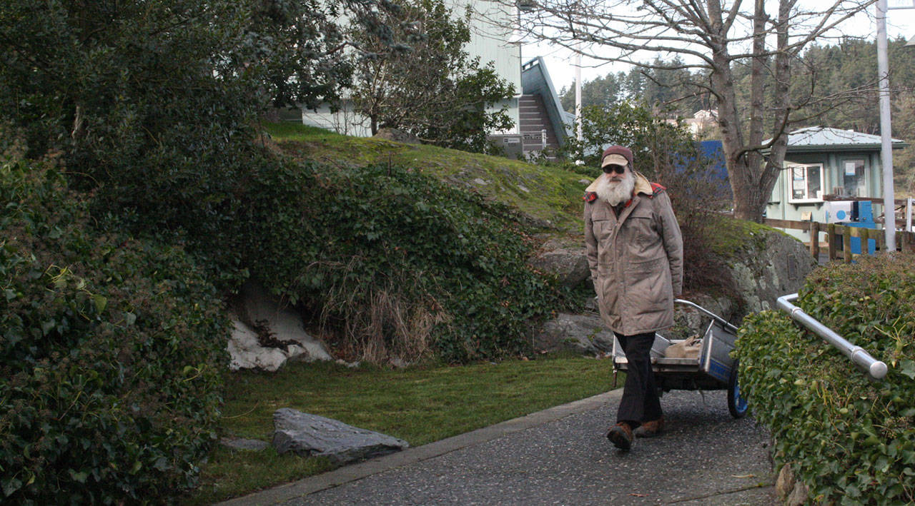 Staff photo/Hayley Day                                A man walks past the ports filled fountain on Jan. 15.