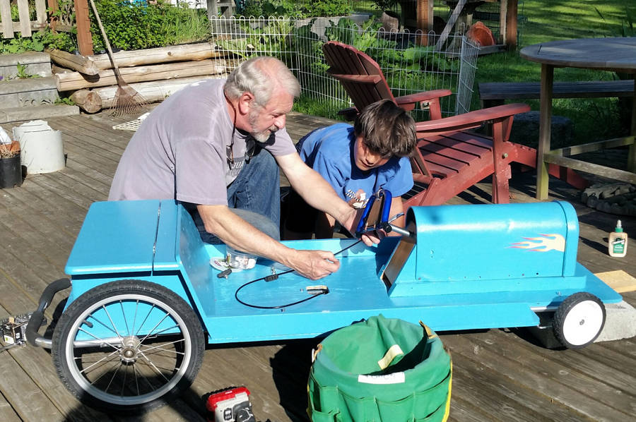 Contributed photo                                Craig Staude and Eric Corbin creating a soapbox car.