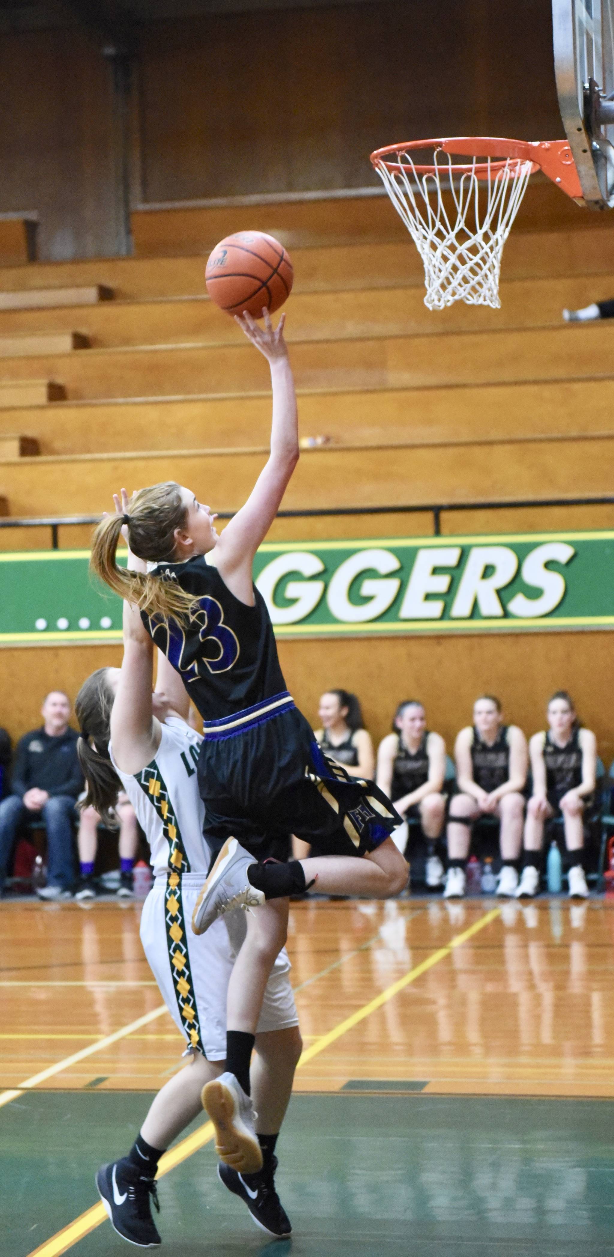 Piper Taylor glides to the basket and two points. / John Stimpson photo