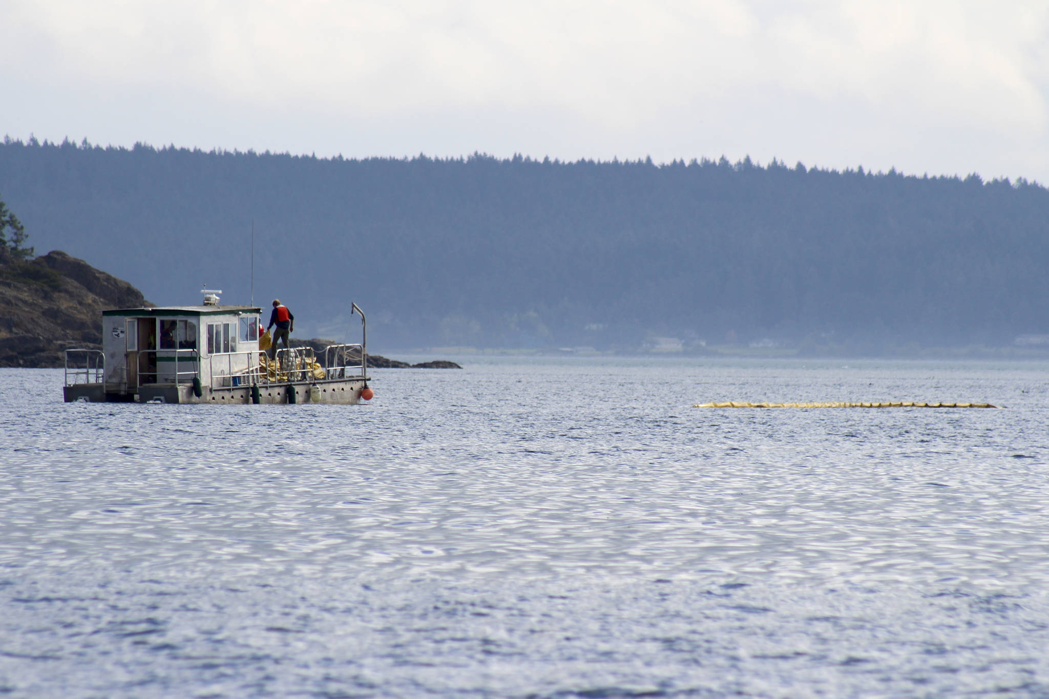 Volunteers from IOSA held a training exercise off Jackson Beach on Saturday, Sept. 21. Here they can be seen deploying a containment boom. <em>(Heather Spaulding/staff photo)</em>