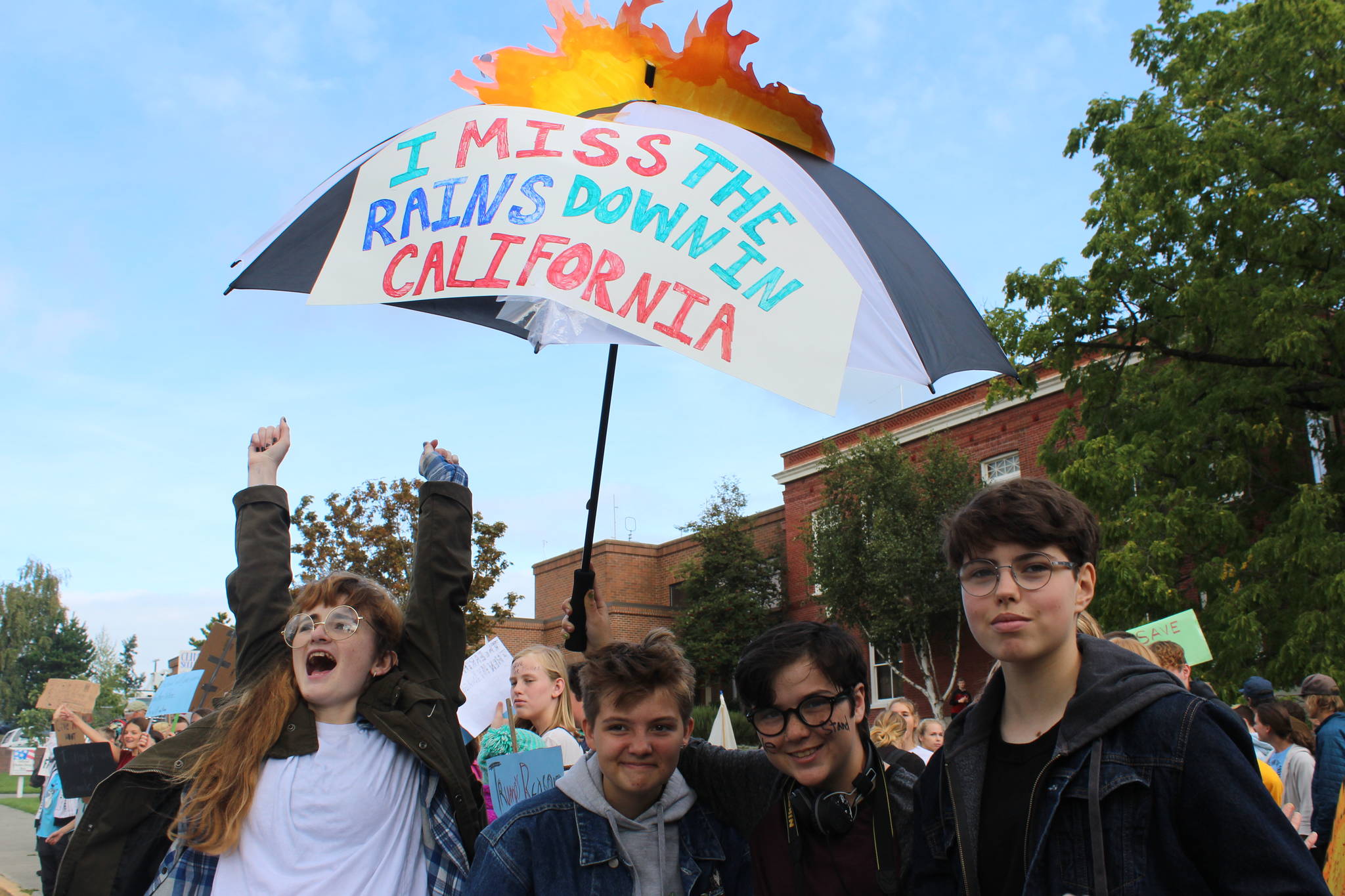 Students show off their sign at the Global Climate Strike. <em>(Heather Spaulding/staff photo)</em>