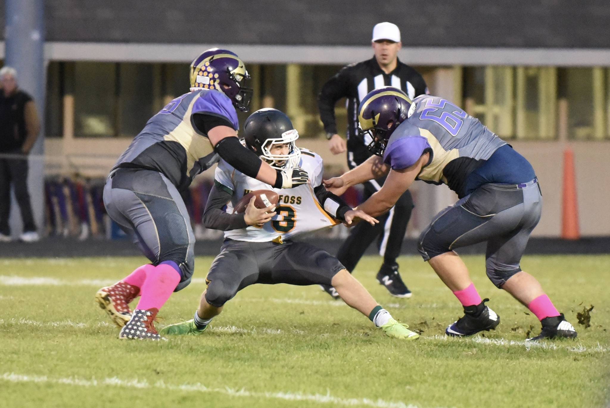# 68 Weston Swirtz and #65 Ty Vague wrap up the Falcons quarterback for a yardage loss. John Stimpson/Contributed photo.