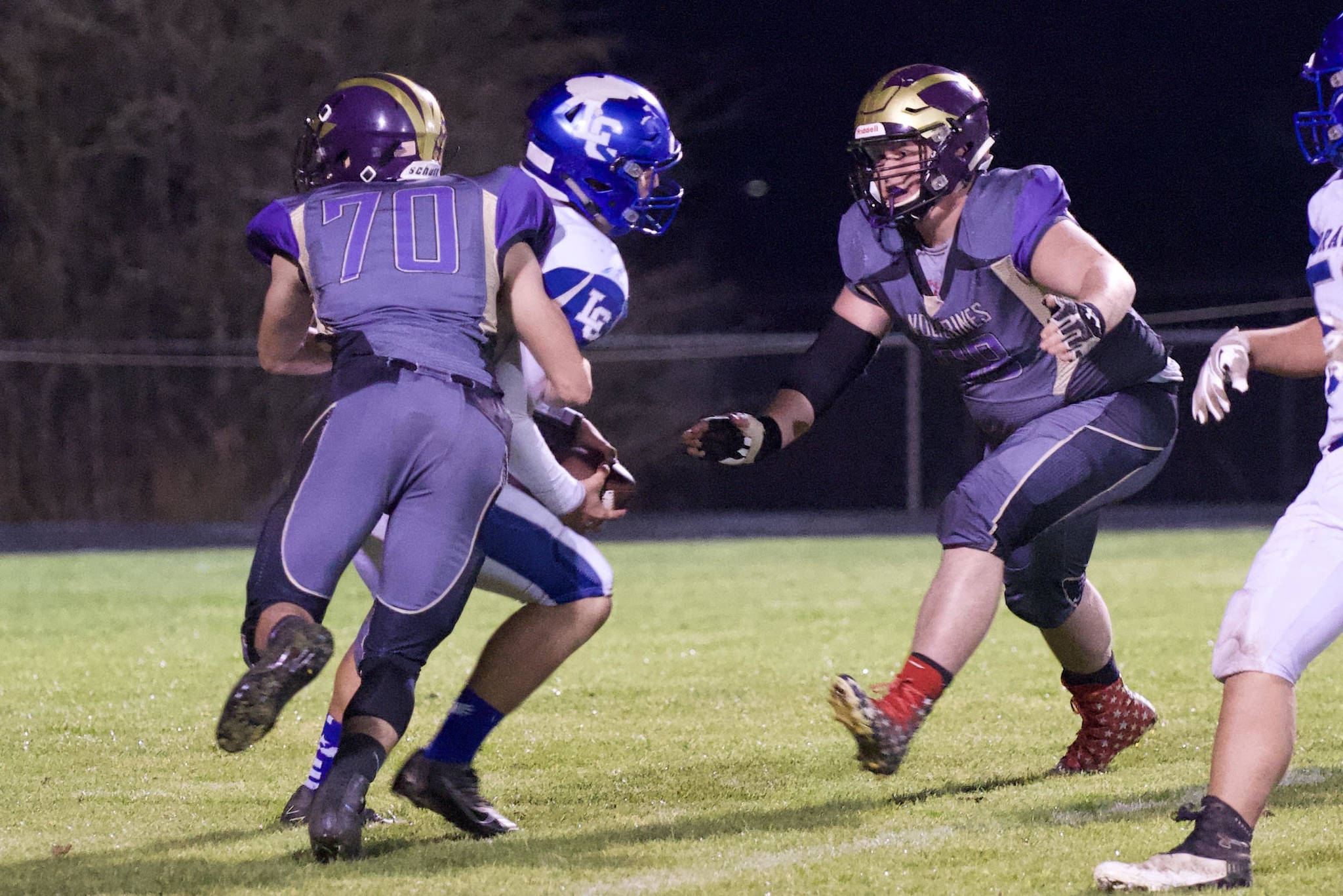Will Leeming, No. 70, and Weston Swirtz, No. 68, put the stop on the Braves ball carrier. (John Stimpson/Contributed photo.)