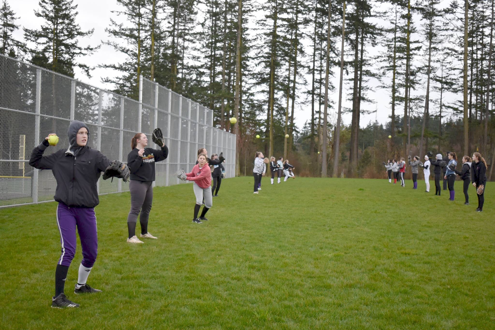 Tate Thomson/Staff photo                                Players warm up during softball tryouts. Follow the Journal to see the 2020 team photo.