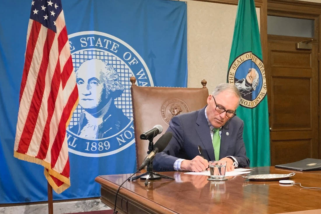 Gov. Jay Inslee signs legislation to help with the state’s response to the COVID-19 outbreak, including $200 million for emergency response. The bill signings was held with limited attendance while the public watched live video and media asked questions via teleconference. (Office of the Governor Photo)