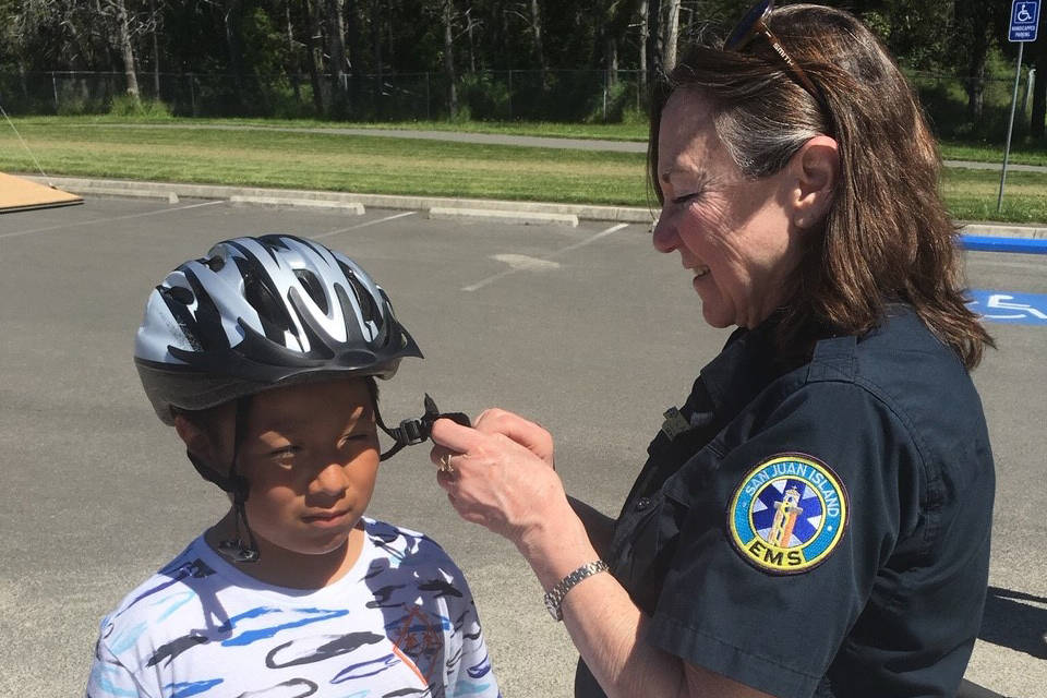 EMT Lainey Volk with community member during a bike fitting session pre-COVID-19. (Contributed photo)