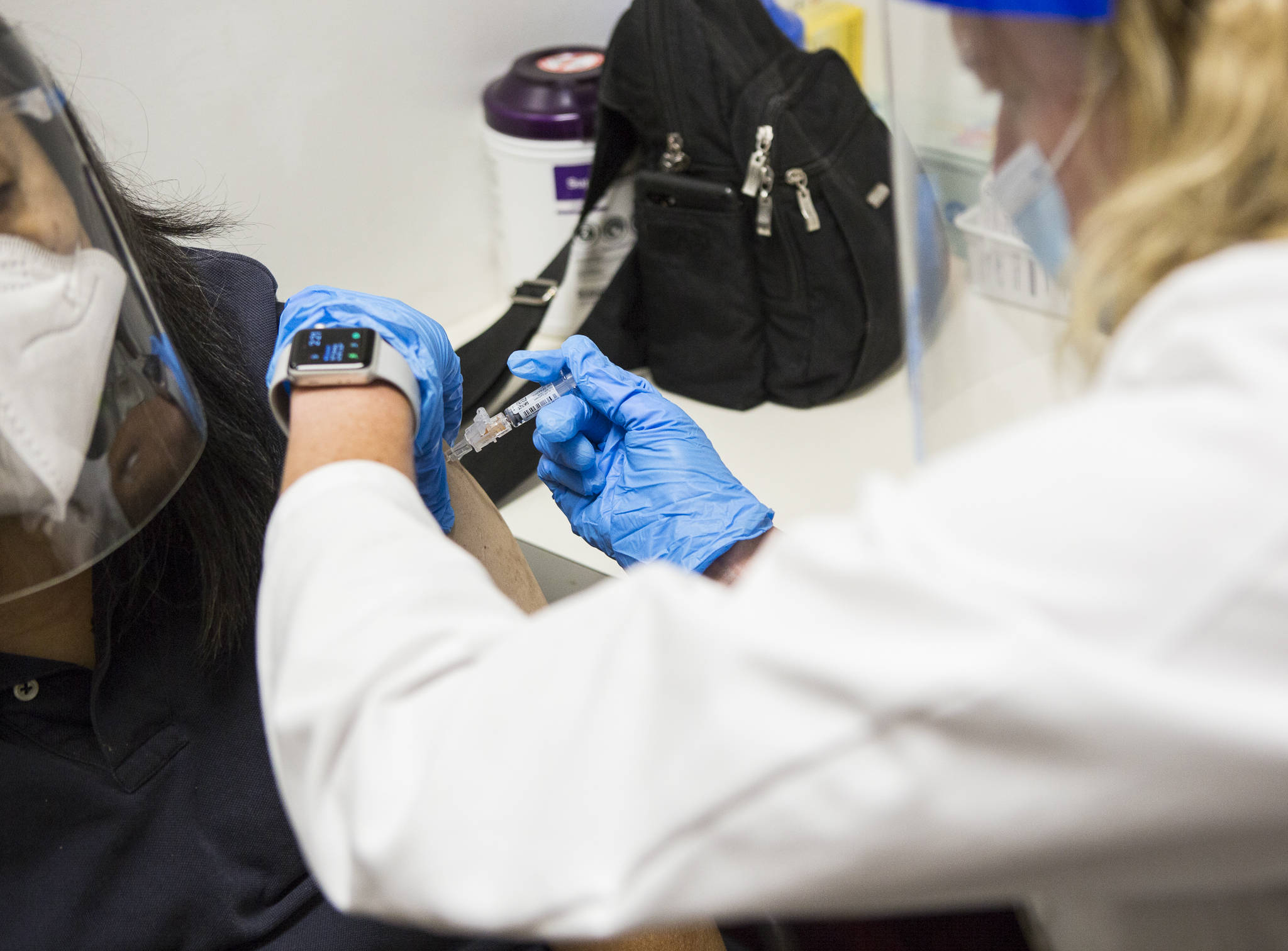 QFC pharmacist Becky Buerhaus administers a flu shot on Wednesday in Everett. (Olivia Vanni / The Herald)