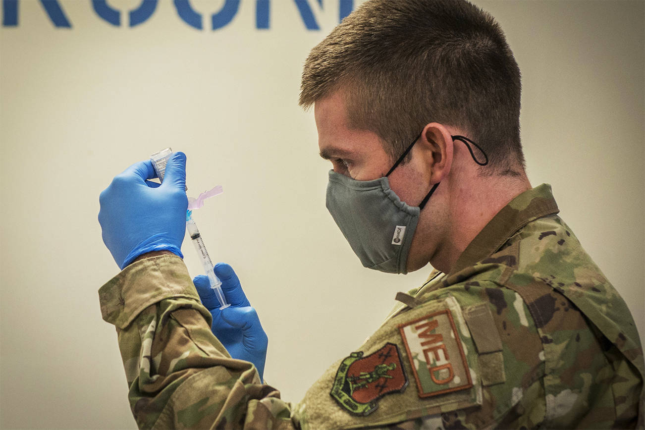 EAST GRANBY, Conn. - U.S. Air Force Capt. Greg Flis, 103rd Medical Group nurse practitioner, draws Moderna COVID-19 vaccine from a vial into a syringe at Bradley Air National Guard Base in East Granby, Connecticut, Dec. 30, 2020. The Connecticut National Guard began administering the vaccine in accordance with the Department of Defense COVID-19 vaccine distribution plan, with doses voluntarily administered to Soldiers and Airmen on the front lines of the COVID-19 pandemic response.